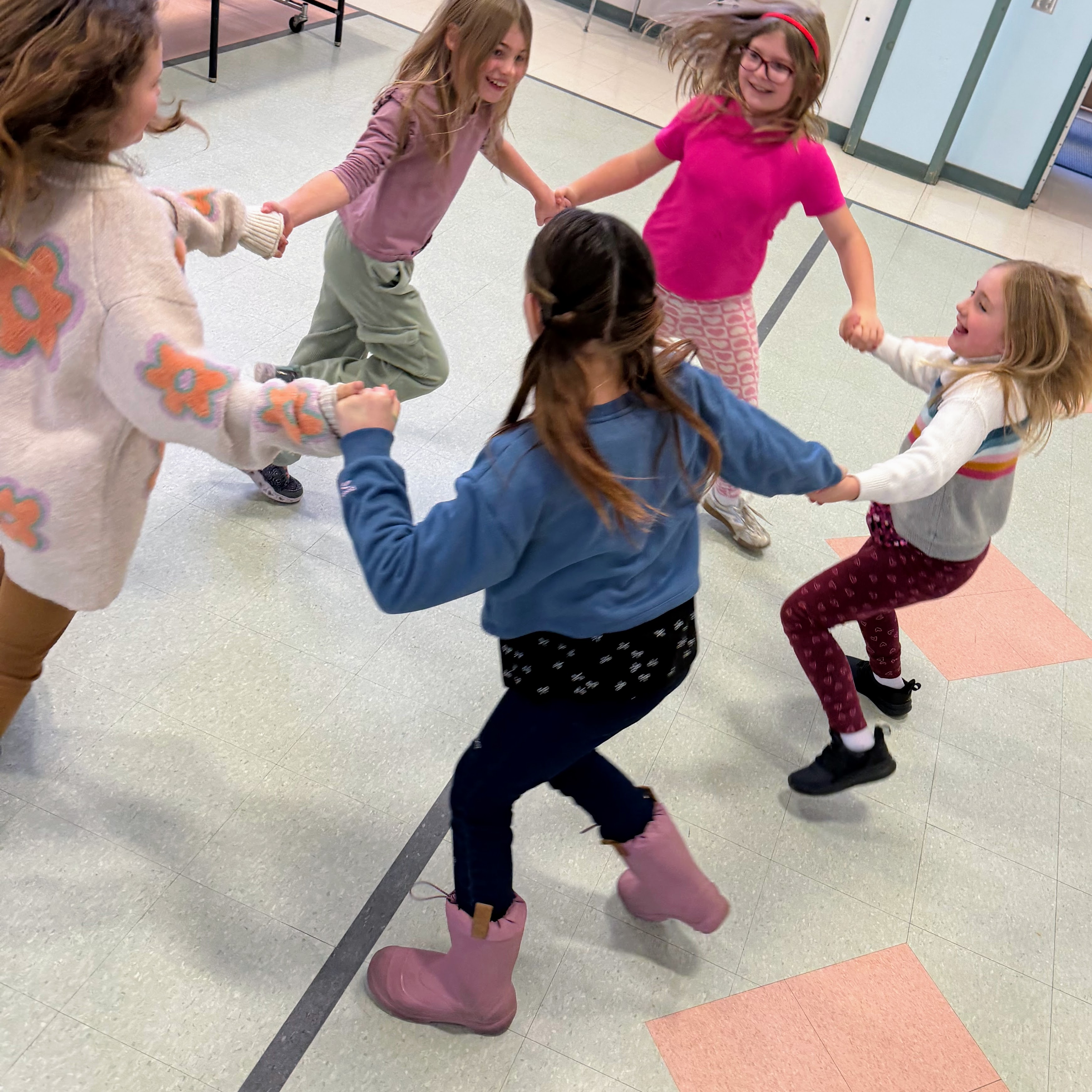 Students dance in a circle